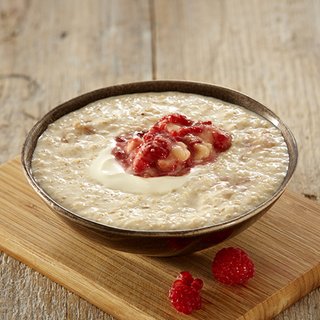 Creamy banana porridge with mish-mash raspberries